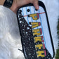 Pouch with 'PARKER' printed on it held by a hand against a white fluffy background