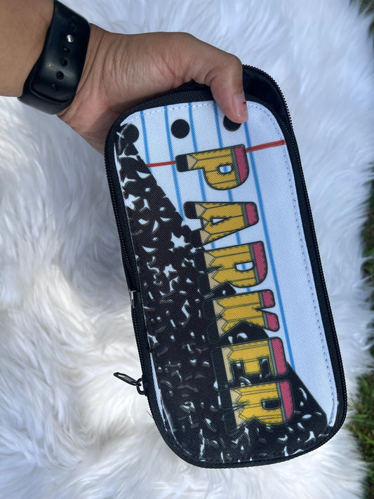 Pouch with 'PARKER' printed on it held by a hand against a white fluffy background